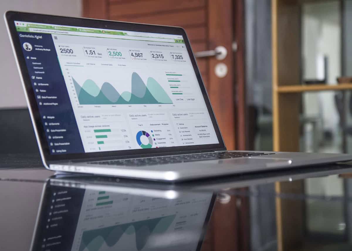 Small business owner reviewing website cost on laptop